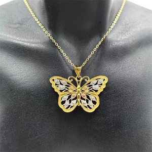 Macro detail of S925 sterling silver butterfly pendant with tri-color filigree craftsmanship