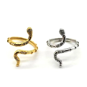 Vue détaillée des bagues serpent entrelacées en or et argent avec pierres de zircon blanc