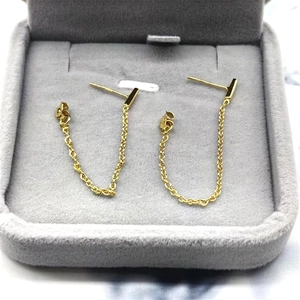 Macro detail of S925 sterling silver gold chain earrings in a velvet jewelry box