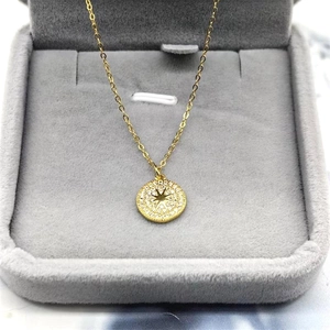 Detailed close-up of a gold-plated S925 silver starburst pendant with white zircon stones
