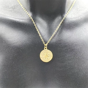 Detailed close-up of S925 silver gold-plated starburst medallion necklace with zircon inlay