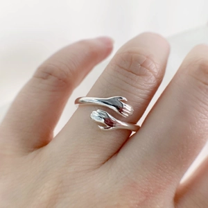 Detailed close-up of a S925 sterling silver hug ring with adjustable open band design