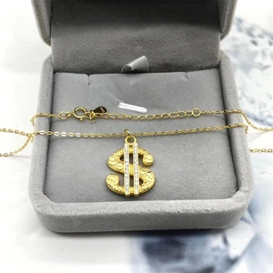 Macro detail of S925 hallmark on gold-plated dollar sign necklace with cubic zirconia