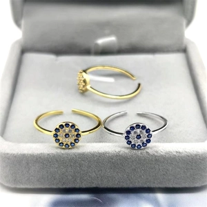 Macro shot of three S925 sterling silver evil eye open rings with blue cubic zirconia