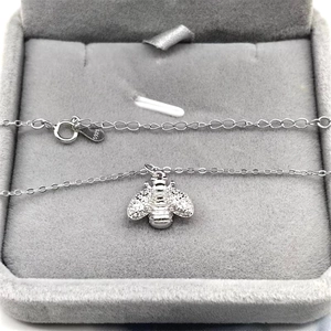 Close-up of S925 sterling silver honey bee pendant showing the hallmark in jewelry box