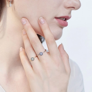 Close-up of gold and silver S925 sterling silver evil eye rings on female hand