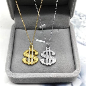 Detail of S925 silver dollar sign pendant necklaces in gold and silver finish with zircons