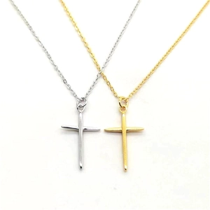 Close-up of minimalist gold and silver cross pendant necklaces with thin O-chains