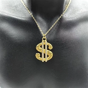 Detailed close-up of a hip hop style golden dollar sign pendant with zircon stones