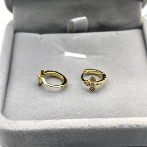 Close-up of S925 sterling silver gold earrings with cubic zirconia cross flower