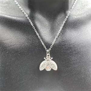 Close-up of S925 sterling silver bee necklace with sparkling cubic zirconia wing detail