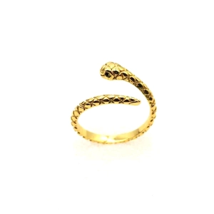 Macro detail of golden snake-shaped open ring featuring engraved scales and black eyes