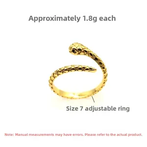 Macro detail of gold snake-shaped S925 silver ring with engraved scales and crystal accents