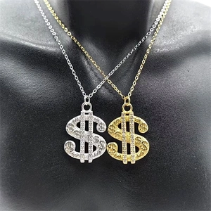 Detailed view of silver and gold dollar sign pendants with white zircons on a neck bust