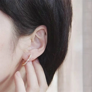 Detail view of a gold-plated S925 sterling silver ear cuff with sparkling pavé zircons