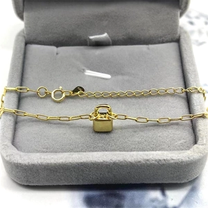 Macro shot of S925 sterling silver gold-plated lock pendant on a velvet jewelry box