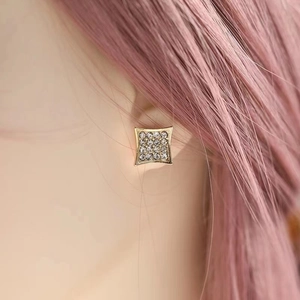 Detail of square gold stud earring with 3x3 crystal matrix worn by model