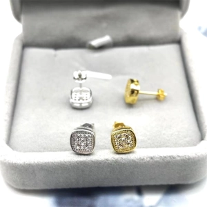 Macro detail of square S925 sterling silver stud earrings in gold and silver finish