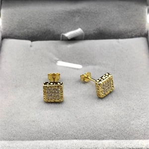 Detail view of square gold S925 silver stud earrings with zirconia in a velvet box