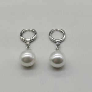 Detail of S925 sterling silver hoop earrings with elegant white round shell pearls