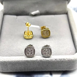 Detailed view of silver and gold square cubic zirconia stud earrings in a jewelry box