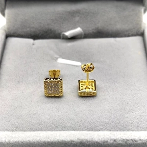 Macro detail of square gold-plated silver stud earrings with pave-set zircon stones
