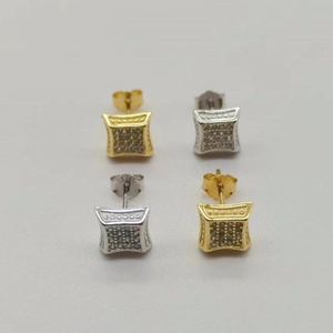 Detailed view of silver and gold square micro-pave stud earrings with zircon stones