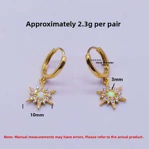 Detail view of gold S925 silver star earrings with white opal and zircon stones