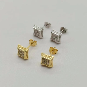 Macro view of square S925 silver stud earrings with pavé zircons in gold and silver