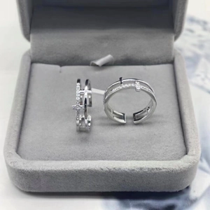 Macro detail of S925 sterling silver double-layer cross ring with zircons in a jewelry box