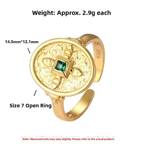 Close-up of S925 sterling silver shield ring with emerald stone and cross relief