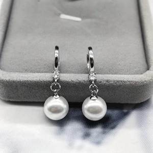 S925 sterling silver pearl drop earrings with zircon accents on gray velvet display