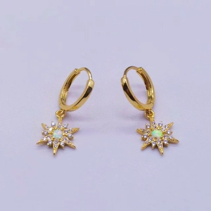 Detailed macro view of S925 silver starburst earrings with opal and zircon in gold finish