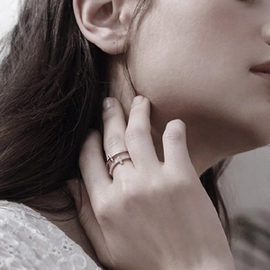 Close-up of S925 sterling silver double-layered cross ring with zircon on a finger