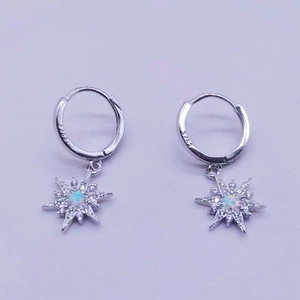 Detail of S925 silver star earrings with iridescent opal and sparkling cubic zirconia