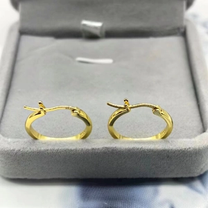 Polished S925 sterling silver gold hoop earrings on a velvet jewelry display tray