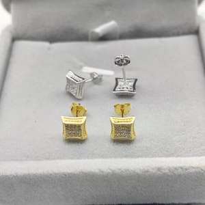 Detail of square zircon stud earrings with pave setting and metallic beaded edges