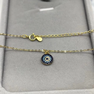 S925 sterling silver gold plated evil eye necklace with blue stones on jewelry box