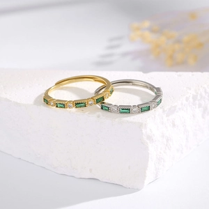 Detail of S925 silver rings with green emerald-cut stones and vintage plating