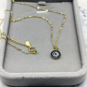 Close-up of S925 hallmark on a gold-plated sterling silver Evil Eye necklace chain