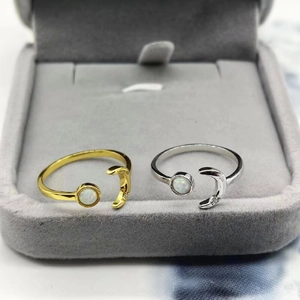 Detail of adjustable star and moon rings with opal inlay and cubic zirconia accents