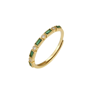 Detail of s925 silver gold ring with green emerald-cut stones and clear zircons