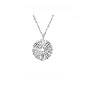 Macro view of S925 sterling silver fan pendant with pleated texture on link chain