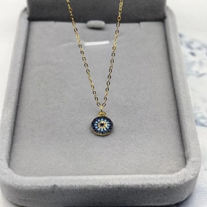 Minimalist S925 sterling silver evil eye necklace with blue stones in a jewelry box