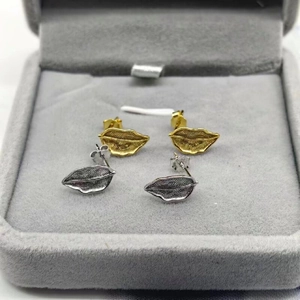 Detail of S925 sterling silver leaf stud earrings in gold and silver finish with leaf veins