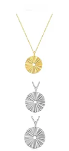 Detail showing gold and silver hollow circular sunburst textured pendants on fine chains