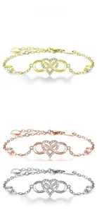 Close-up of infinity heart bracelets in gold, rose gold, and silver with zirconia stones