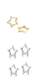 Détail des boucles d'oreilles en forme d'étoile creuse en finitions or et argent