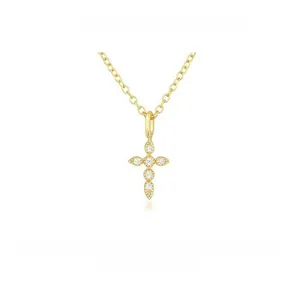 Close-up of gold-plated silver cross necklace with drop-shaped zircon stones