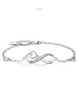 Macro detail of S925 silver infinity heart bracelet with sparkling zircon stones